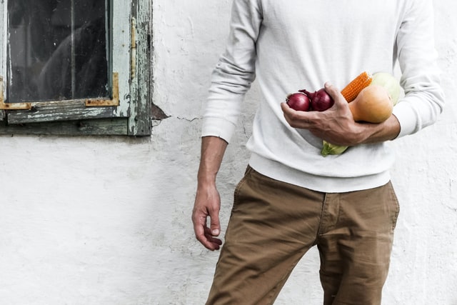 man holding vegetable and fruits